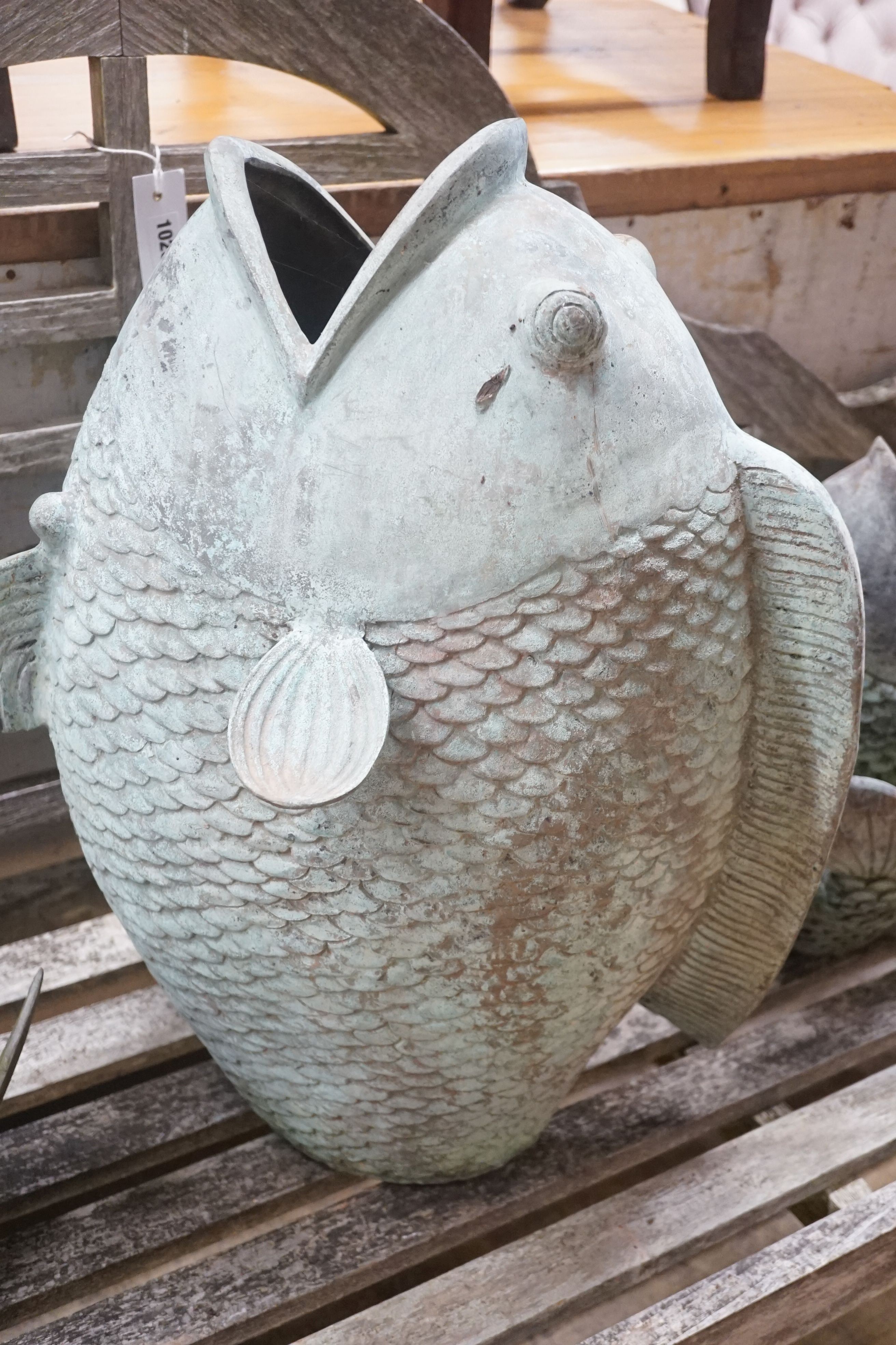 Three cast metal carp garden ornaments, largest 60cm height 46cm